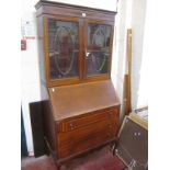 An Edwardian mahogany and crossbanded bureau bookcase with three short drawers on cabriole legs