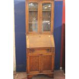 An early 20th Century oak bureau bookcase 180cm high, 64cm wide