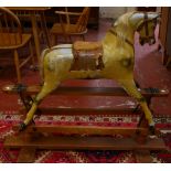 An early 20th Century painted rocking horse on trestle supports