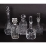 Five assorted glass decanters to include one Dartington decanter