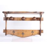 A stained beech hanging coat rack 36cm high, 59cm wide
