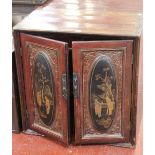 A pair of Chinese lacquer cabinets each with decorated panel to the doors enclosing drawers 71cm