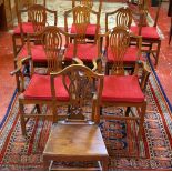 A harlequin set of nine country Hepplewhite oak dining chairs with pierced shield backs including