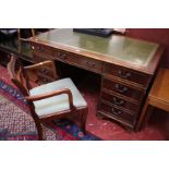 A George III style mahogany pedestal desk with inset writing surface and nine drawers 137cm wide