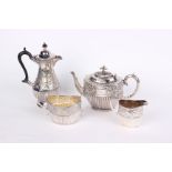 A copper bowl and silver plate tea service