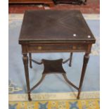 An Edwardian mahogany envelope card table with a frieze drawer on turned legs joined by X-