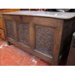 An 18th Century oak carved coffer with triple panel carved front 69cm high, 126cm wide