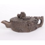 A Yi Xing teapot, styled as tree slice with modelled rodent figures.