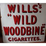 Two large enamel signs advertising Wills cigarettes.