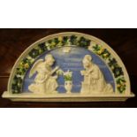 A Della Robbia pottery plaque depicting Mary Magdalene being visited by an angel (af)L: 44cm