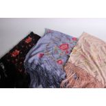 A black silk fringed shawl embroidered with flowers in shades of pink and red; a blue silk fringed