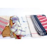 A quantity of early 20th Century household linens; comprising linen tea towels, checked