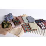 A large collection of textiles; comprising colourful woven pelmets, cushions, patchwork pieces,