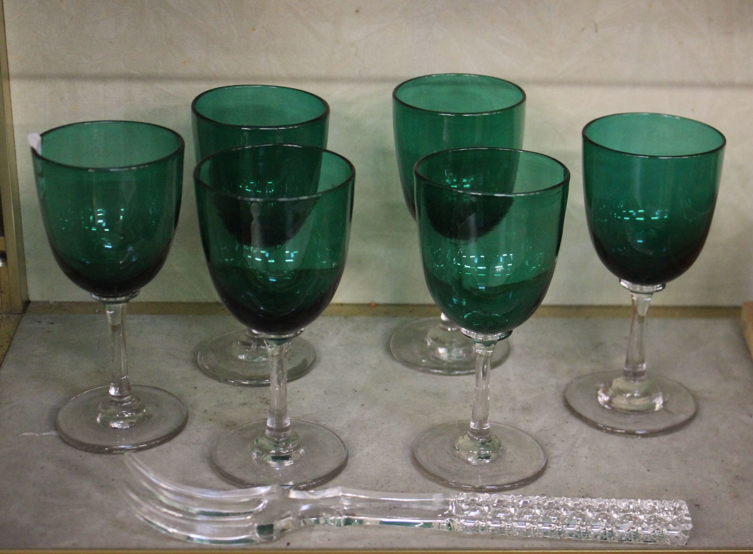 A set of six green wine glasses and twelve gilt edge side plates