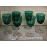 A set of six green wine glasses and twelve gilt edge side plates