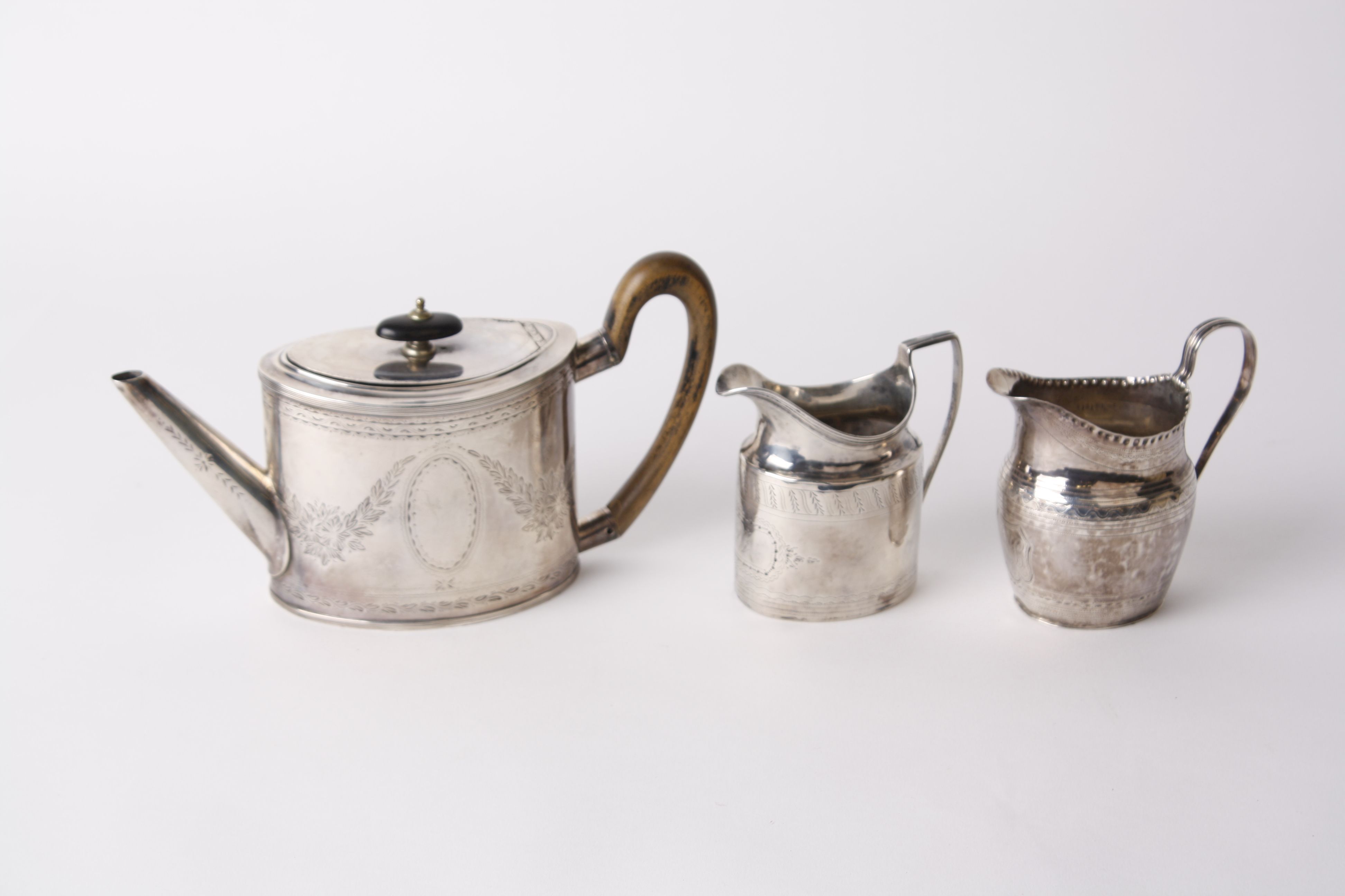 A 19th century Duth oval small teapot, the straight sides engraved with leaves and oval cartouche, - Image 2 of 2