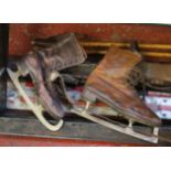 Vintage ice skating skates, skis, ski poles and a fender