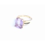 A continental amethyst single stone ring, the rectangular cut-corner step-cut stone approx 4.90