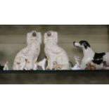 A group of pottery and porcelain animals including a graduated set of three fox terriers