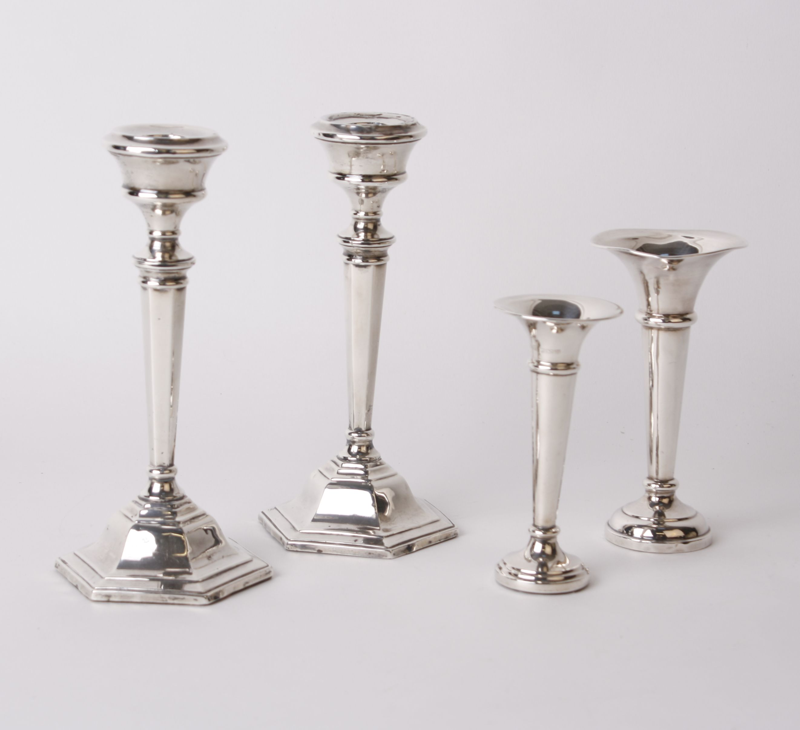 A pair of silver candlesticks Sanders & Mackenzie, Birmingham, 1964, and a pair of silver spill