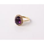 A continental 18 ct gold Amethyst and diamond oval cluster ring, size M, 6 g