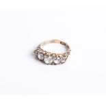 A late Victorian gold and diamond five stone carved half-hoop ring with rose diamond points, the