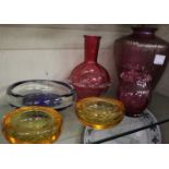 A cranberry glass vase and other coloured glassware