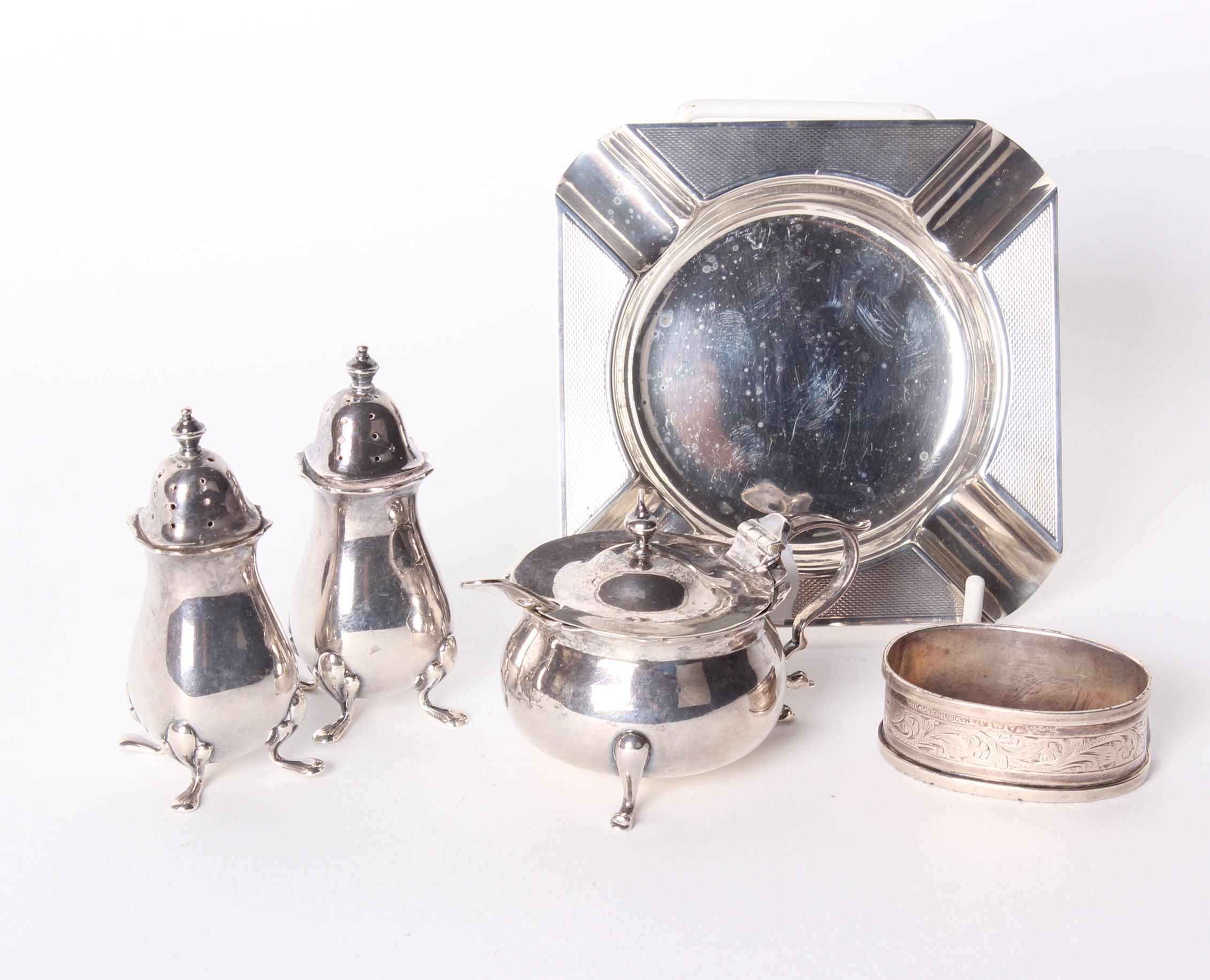 A silver salt cellar, F & Co, Birmingham, 1904, pair of shakers, napkin ring and ashtray 6ozt