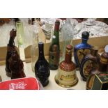 A Collection of Glass Figural Bottles together with a quantity of drink related advertising items