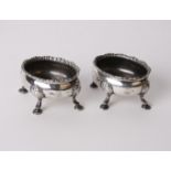Silver; a pair of George III open salts with reeded wavy rims and shell and hoof feet. Robert