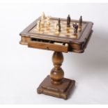 A pedestal chess table complete with resin chess set (In drawer).