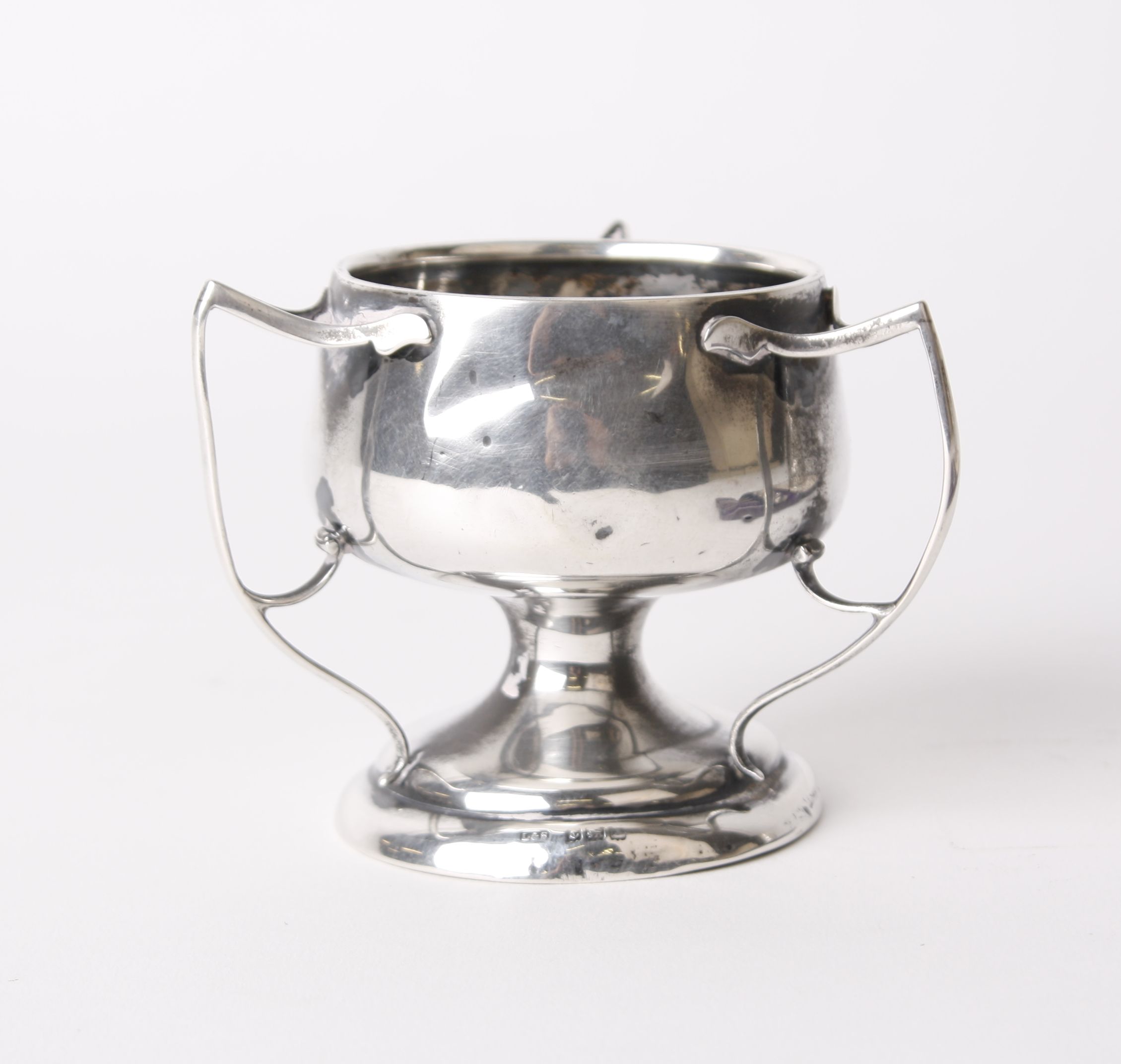 Silver; a three handled circular base pedestal bowl, Birmingham circa 1940's, a silver cased scent