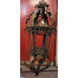 An Italian wrought iron and gilded hanging lantern of hexagonal outline, h: 102cm, suspended on a