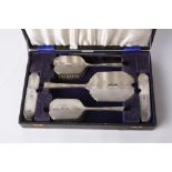 A silver mounted dressing table set, Birmingham 1940 by Adie Bros Ltd, engraved with script