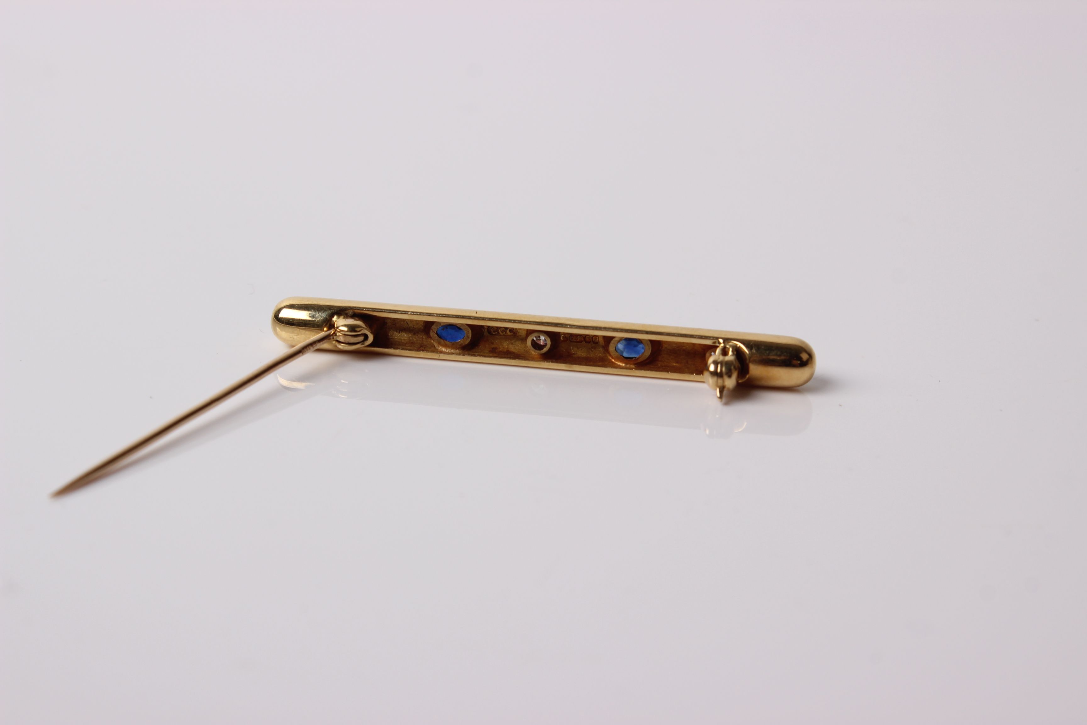 An 18 ct gold, sapphire and diamond five stone bar brooch the three round brilliant diamonds approx. - Image 2 of 2