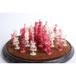 A Chinese design ivory chess set, pieces on concentric ball mounts, well carved horsemen,