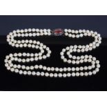An Early/Mid 20th Century two strand of cultured pearls with a silver and enamel clasp