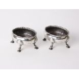 Silver; a pair of George III open salts with reeded wavy rims and shell and hoof feet. Marks