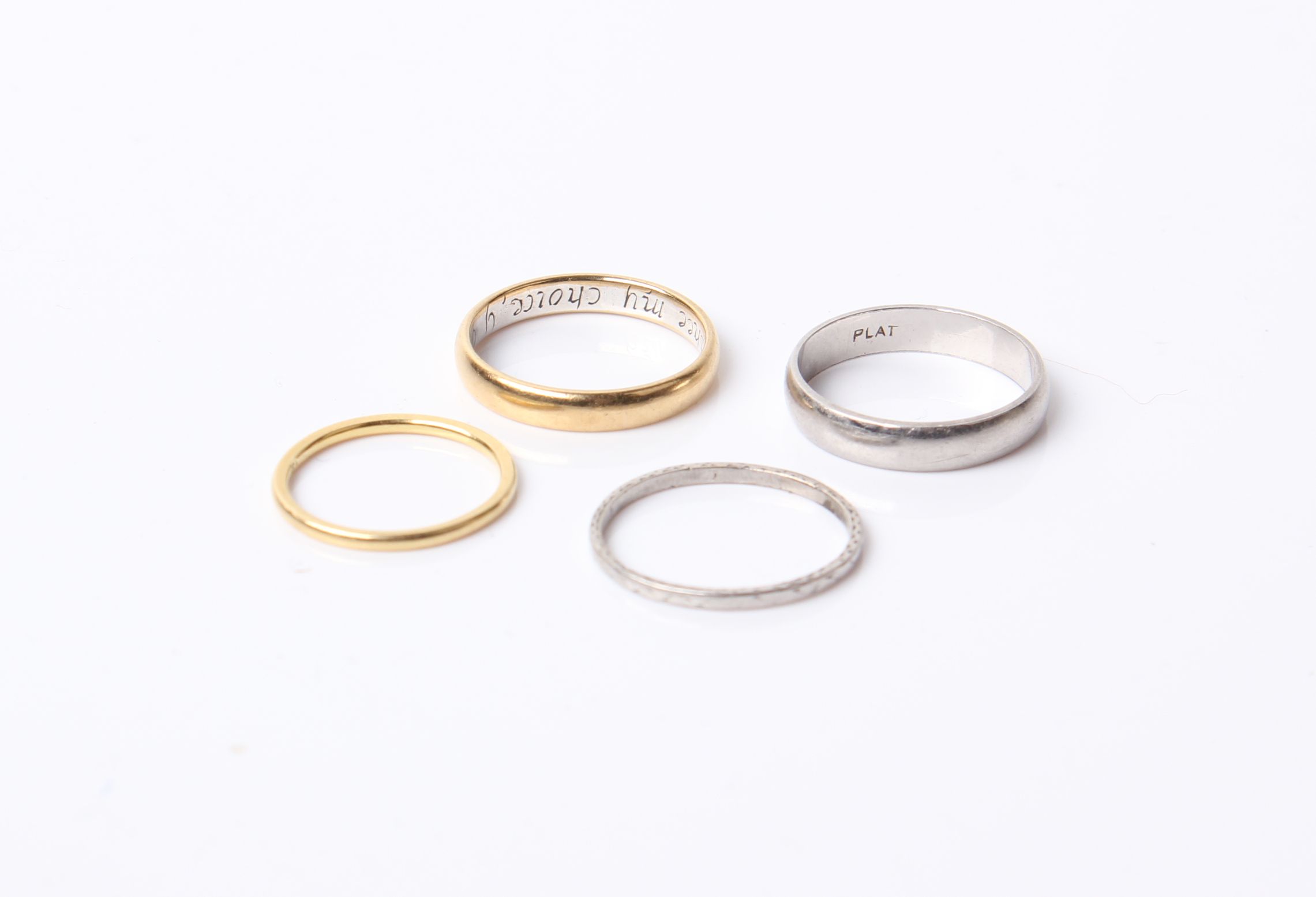 Two early 20th century platinum bands, 6.6g, a yellow metal band ring, marked 1.4g 'FH' and a