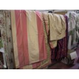 A pair of heavy cream curtains with a green fringed pelmet, brown brocade floral curtains, red and