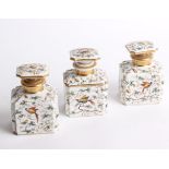 A 19th century porcelain suite of dressing table flasks comprising a pair of scent bottles and a