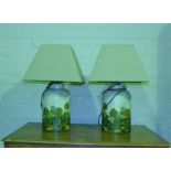A Pair of tin tea caddy lamps, painted with rural scenes