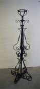 A wrought iron oil lamp stand