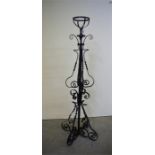 A wrought iron oil lamp stand