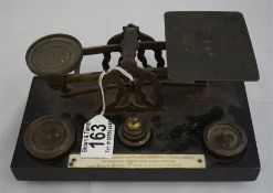 A set of late 19th century brass postal scales on wood plinth plus weights