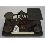 A set of late 19th century brass postal scales on wood plinth plus weights