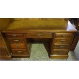 A late 19th century mahogany knee hole desk having 9 drawers with brass pulls and a leather insert