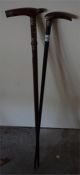 An Ebonised walking stick with silver collar and bone handle and a inlaid hardwood walking stick