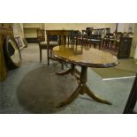 An oval twin pedestal mahogany coffee table