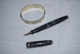 Silver bangle with floral engraved decoration and a parker pen with gold nib